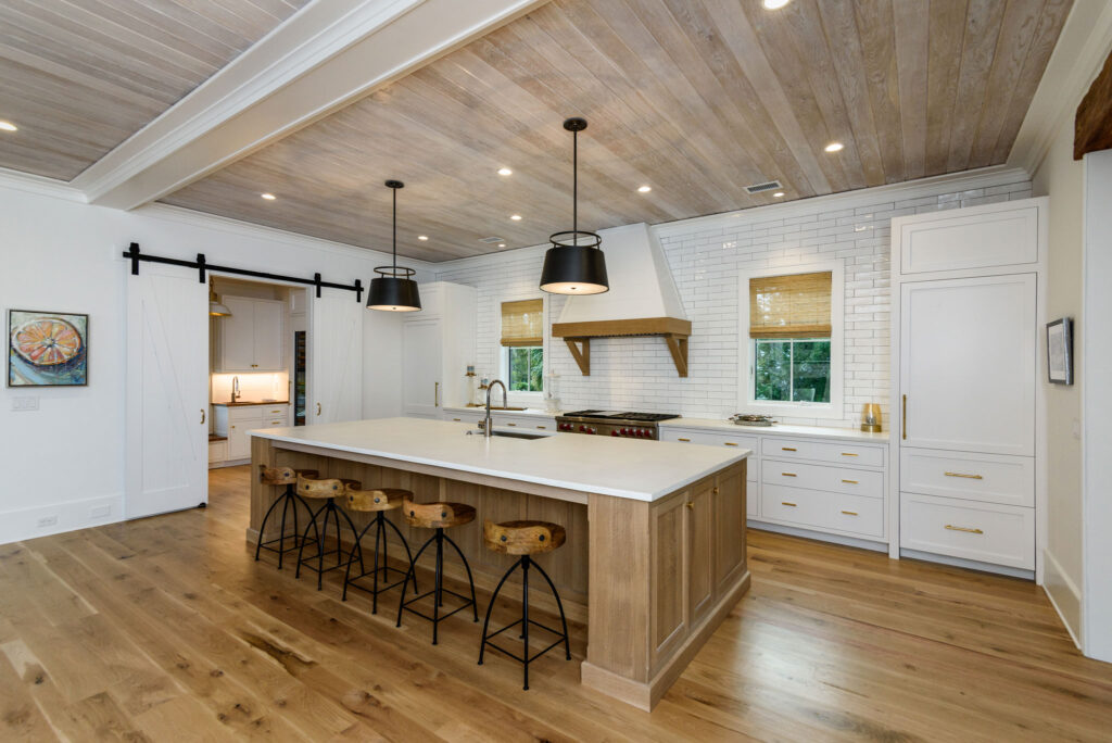 newly renovated kitchen with island and lights over island - - residential architect and structural engineers charleston, SC