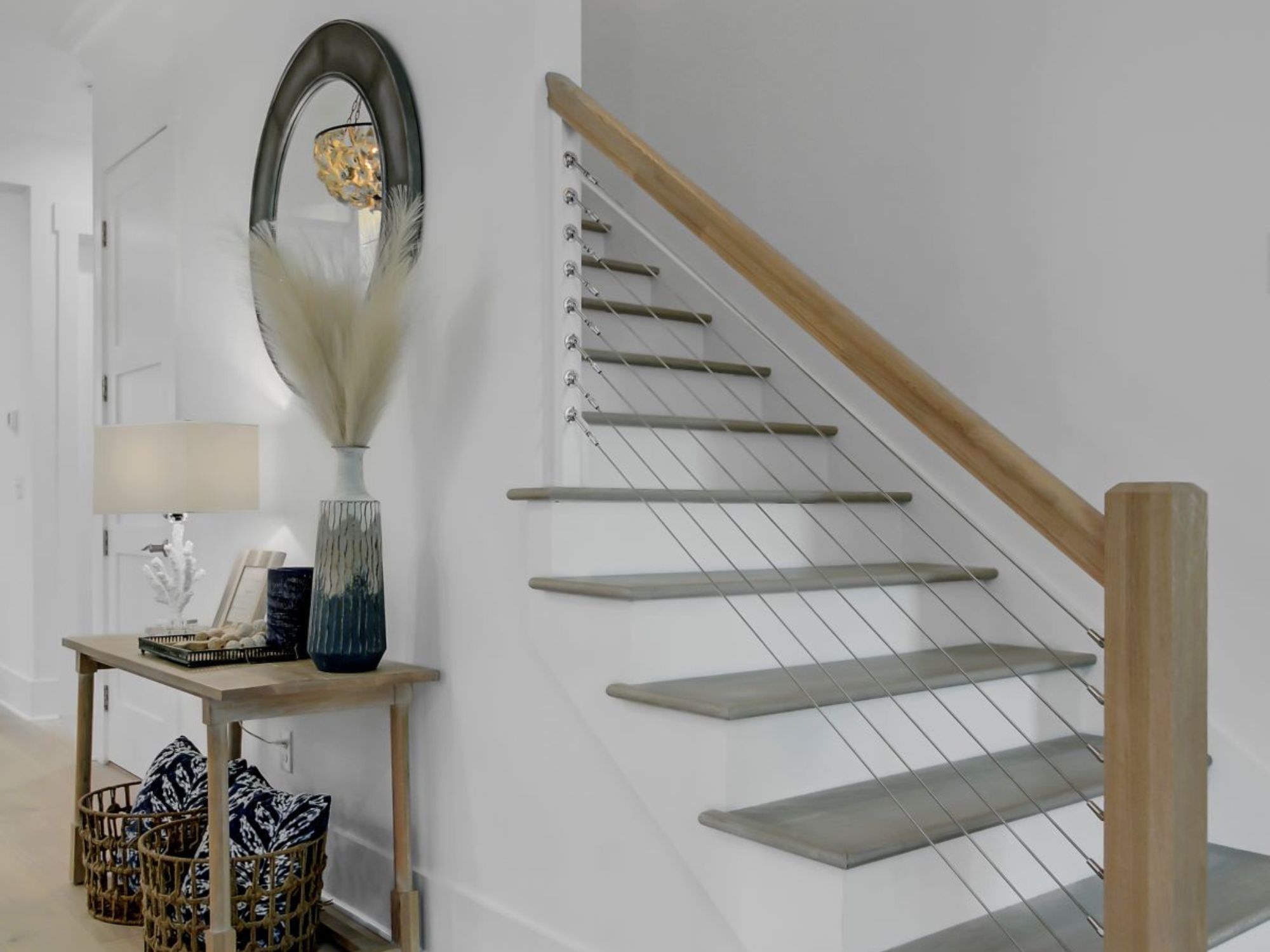 beautiful staircase in a home with entry way table - the coastal creek design difference charleston, SC