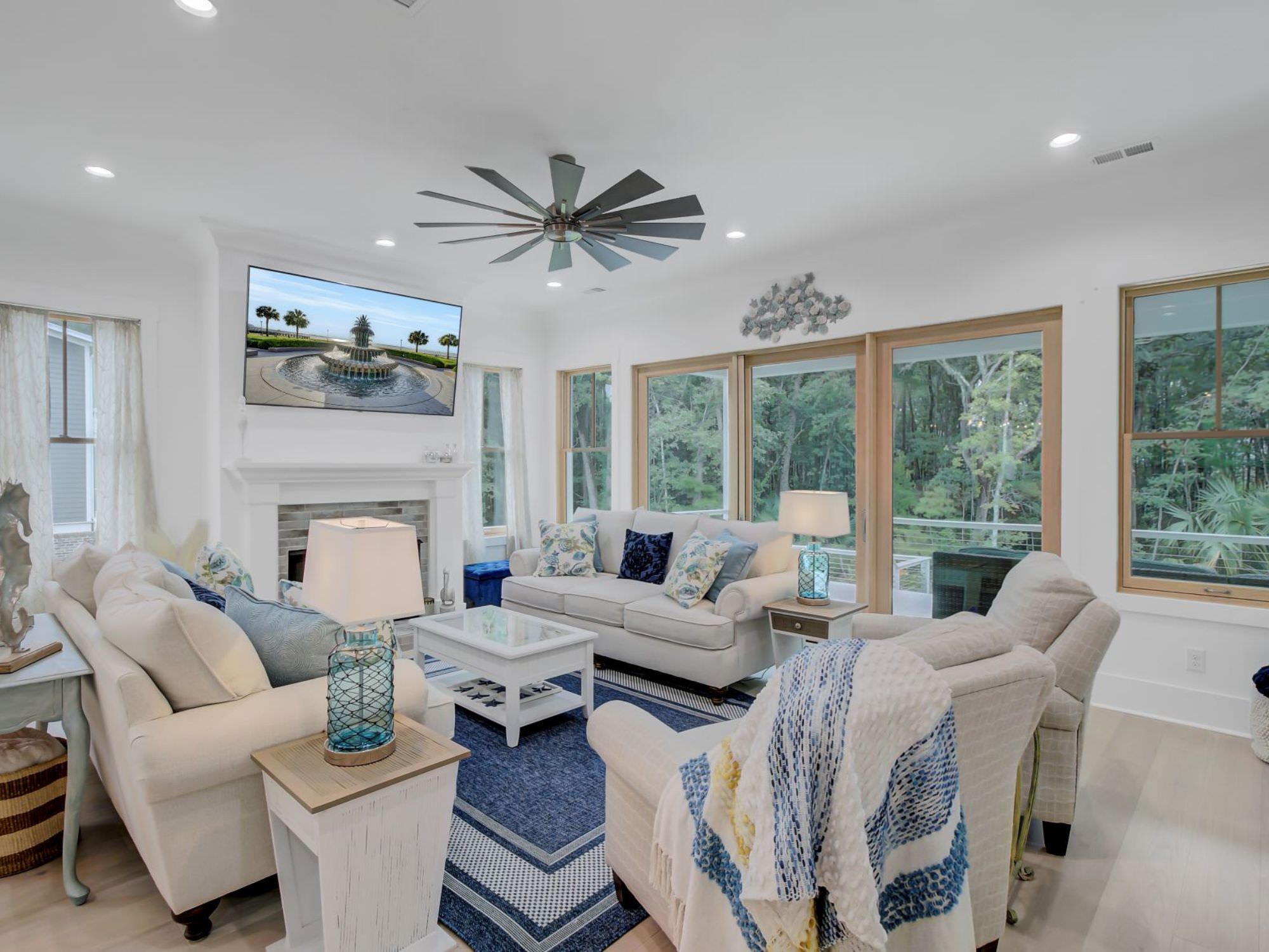 white couches, tables and chairs in a big den