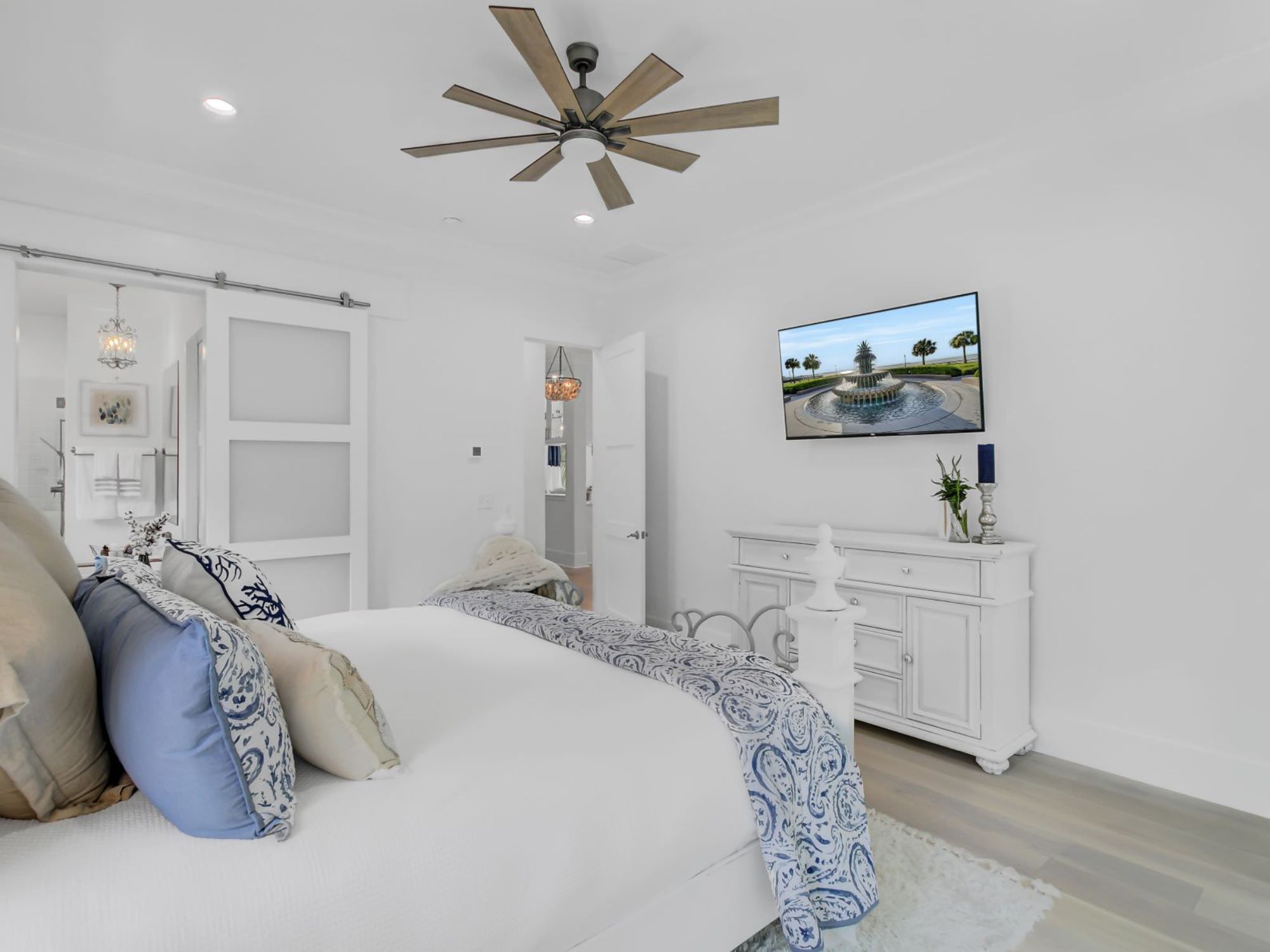 white dresser and bed with blue pillows and blanket - the coastal creek design difference charleston, SC