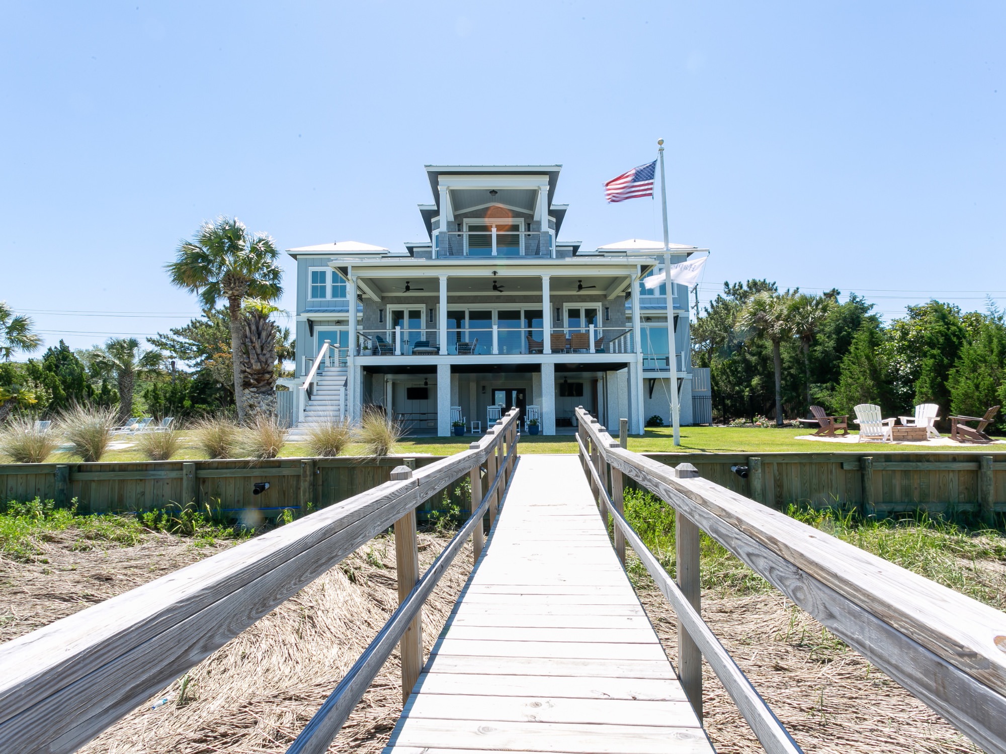 back of home with dock and American Flag - award winning architects