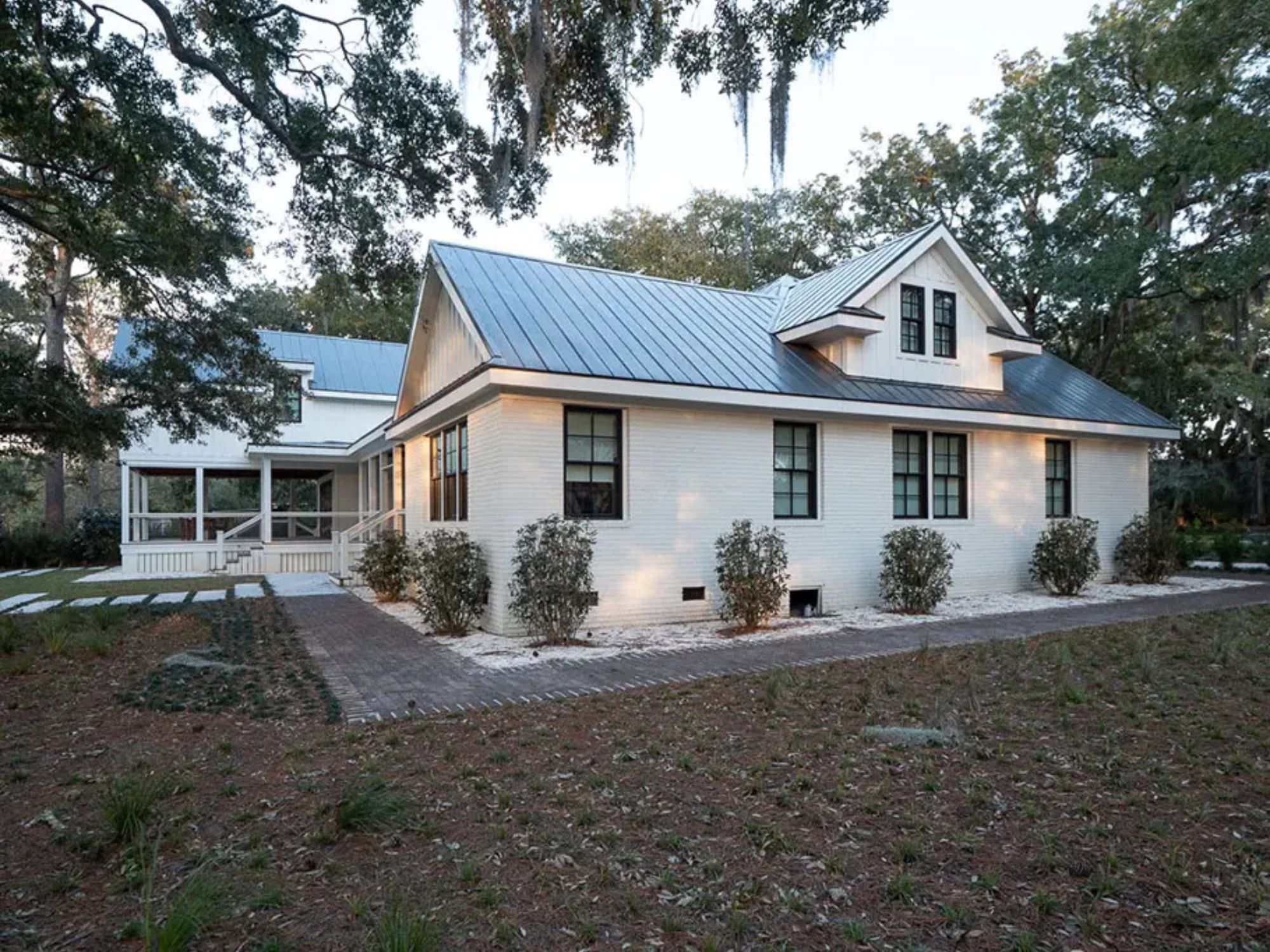 side view of home with bushes and walkways