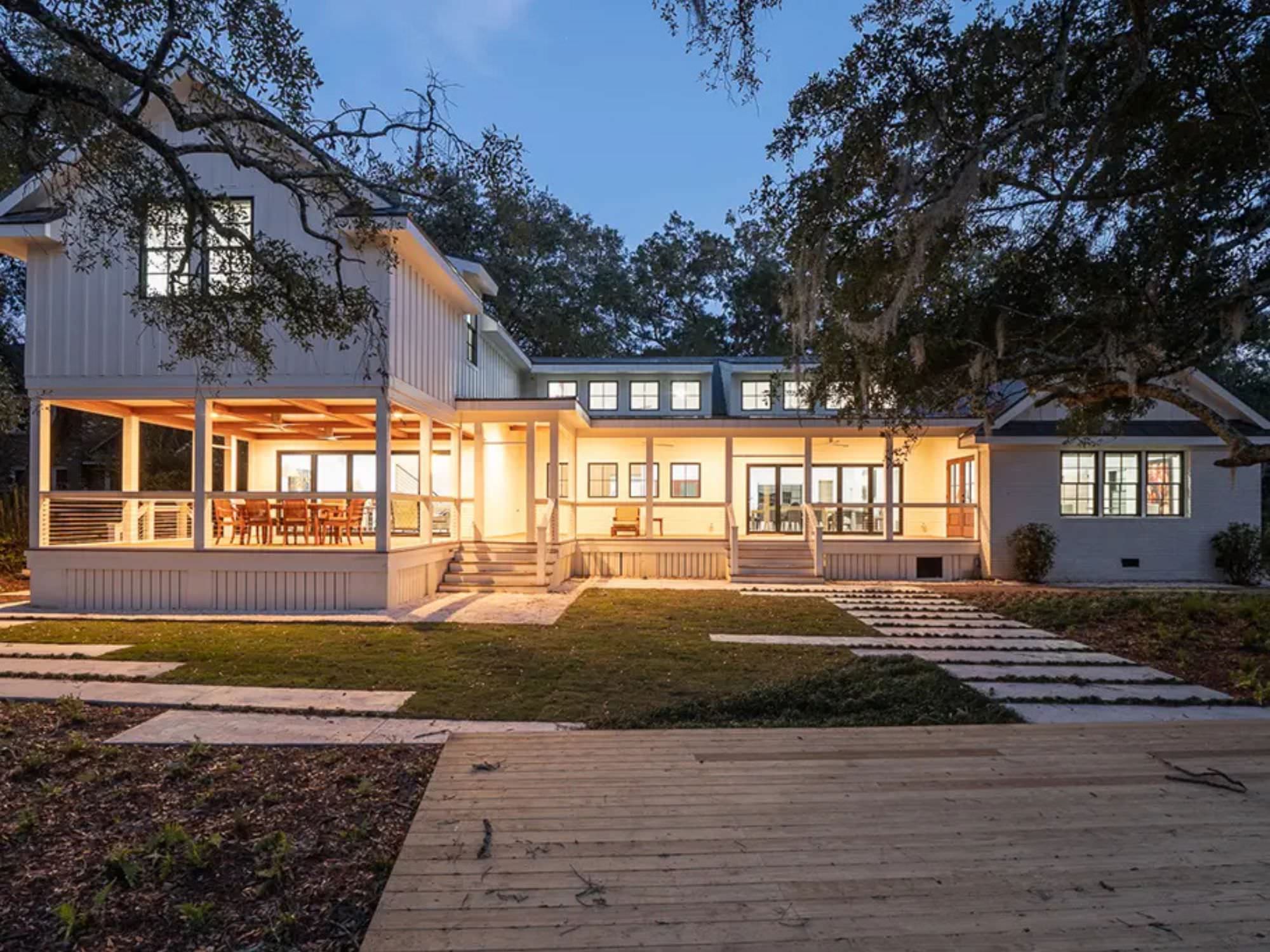 house at dusk with lights on inside and on the porches