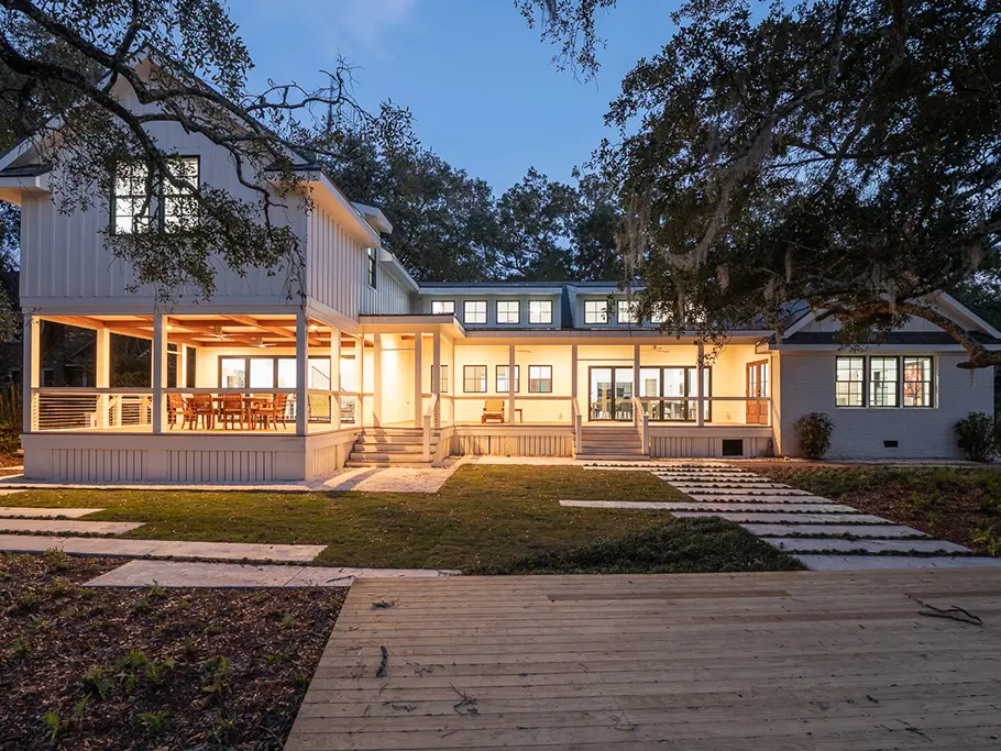 back of lit up home at night - custom home renovation charleston, SC