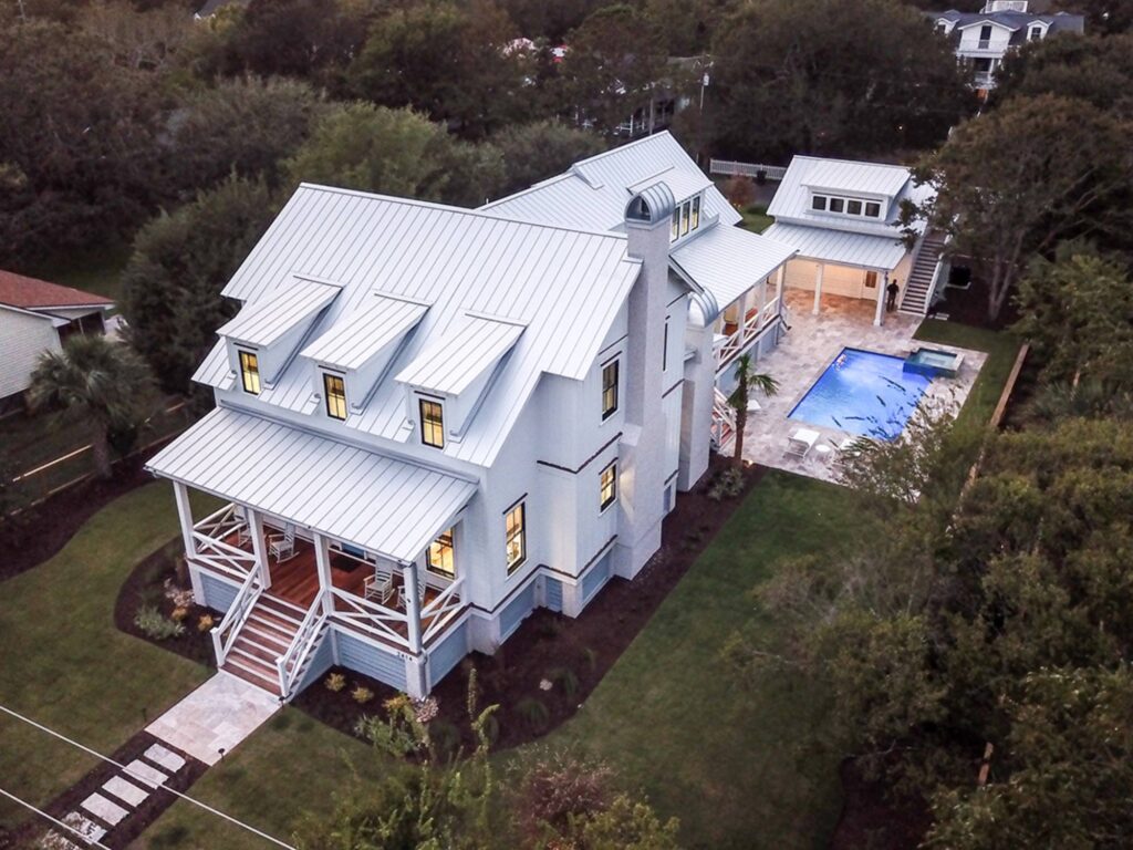 white home with a pool an detached garage in charleston, SC