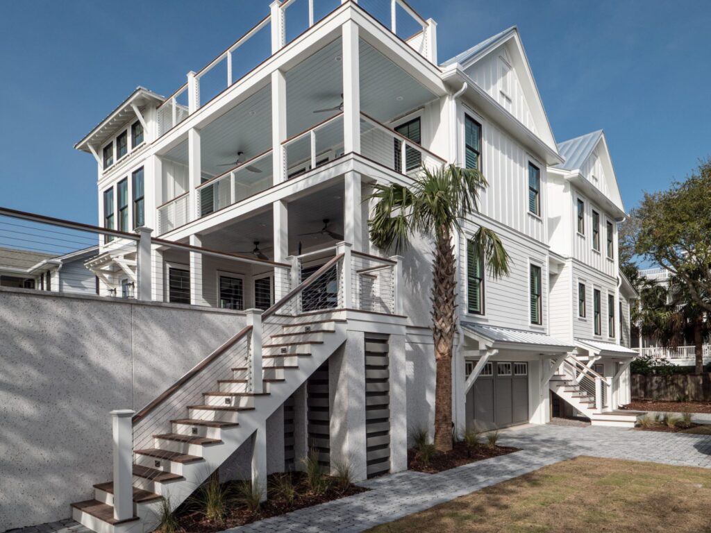 big white home in charleston, SC that has porches on both levels - Elevated house plans for flood zones