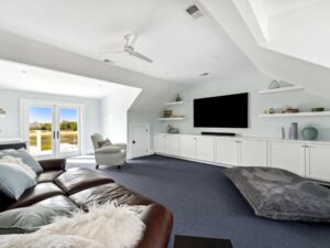 gaming room with couch, chairs, large tv - room addition