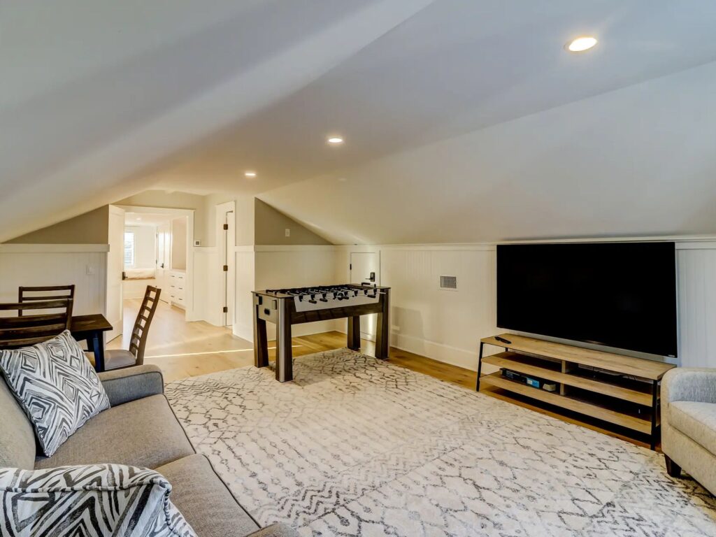 upstairs gaming room with couch, chair, tv - whole home remodel, charleston, SC