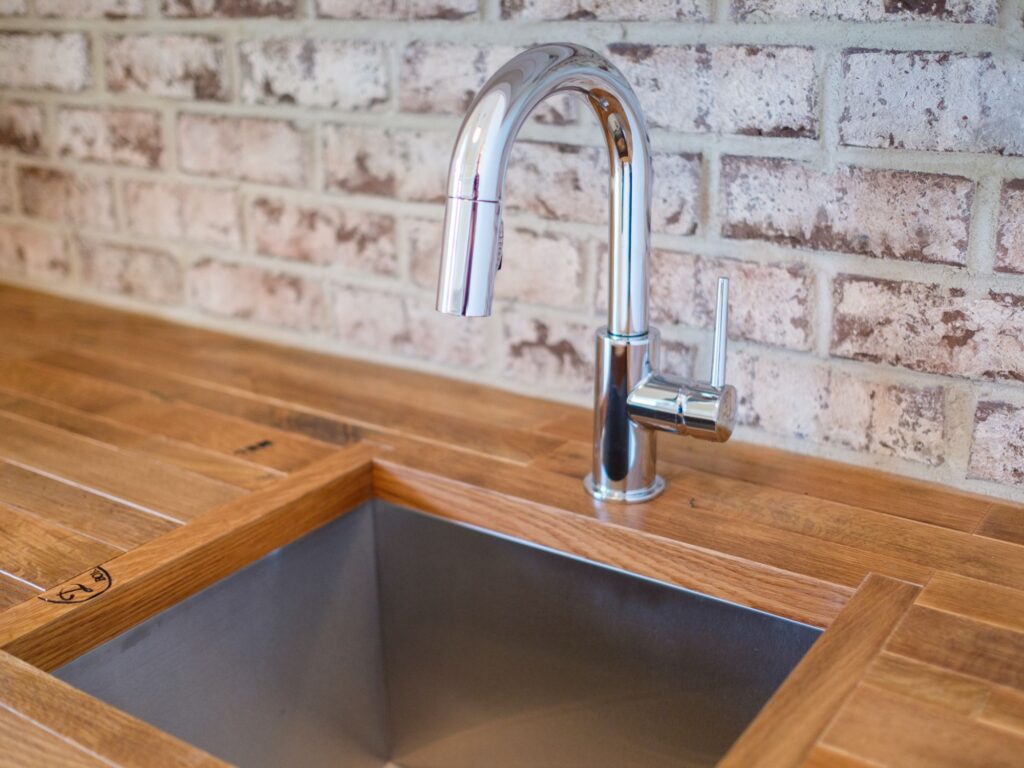 high end stainless steel sink in wood platform