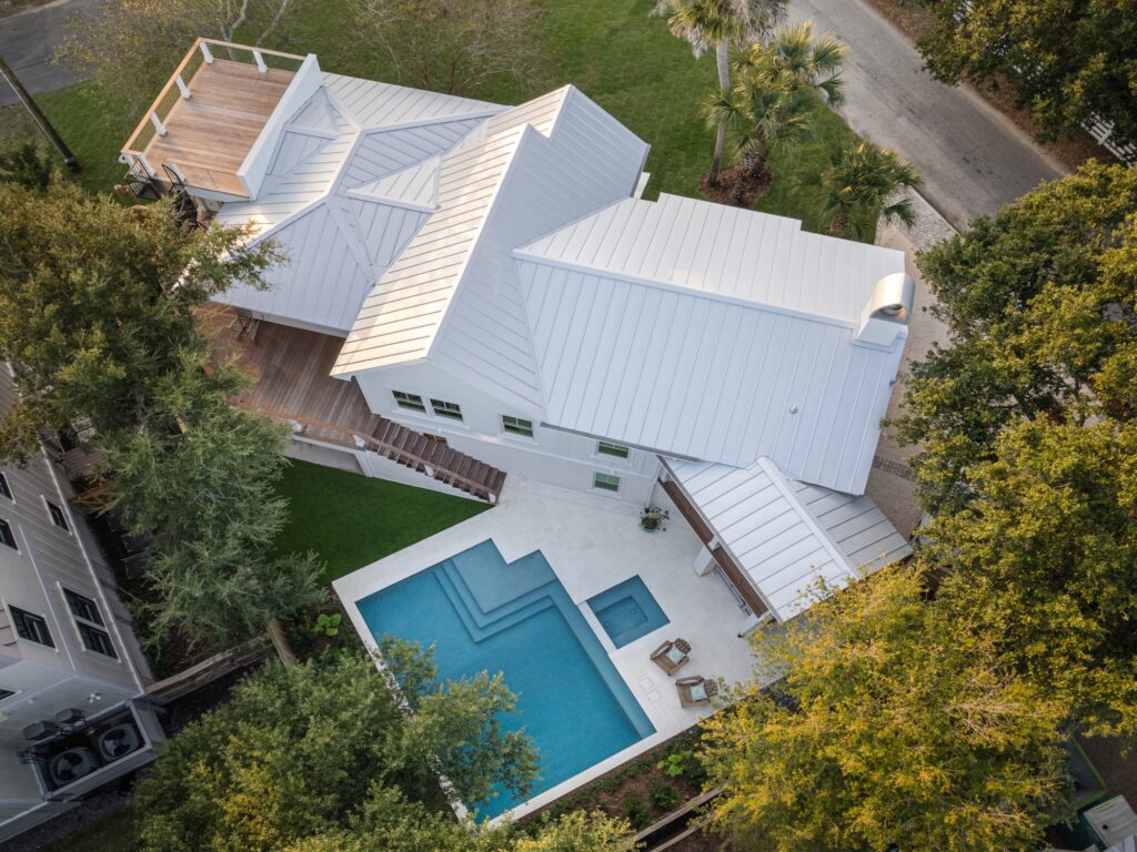 aerial view of white home with pool