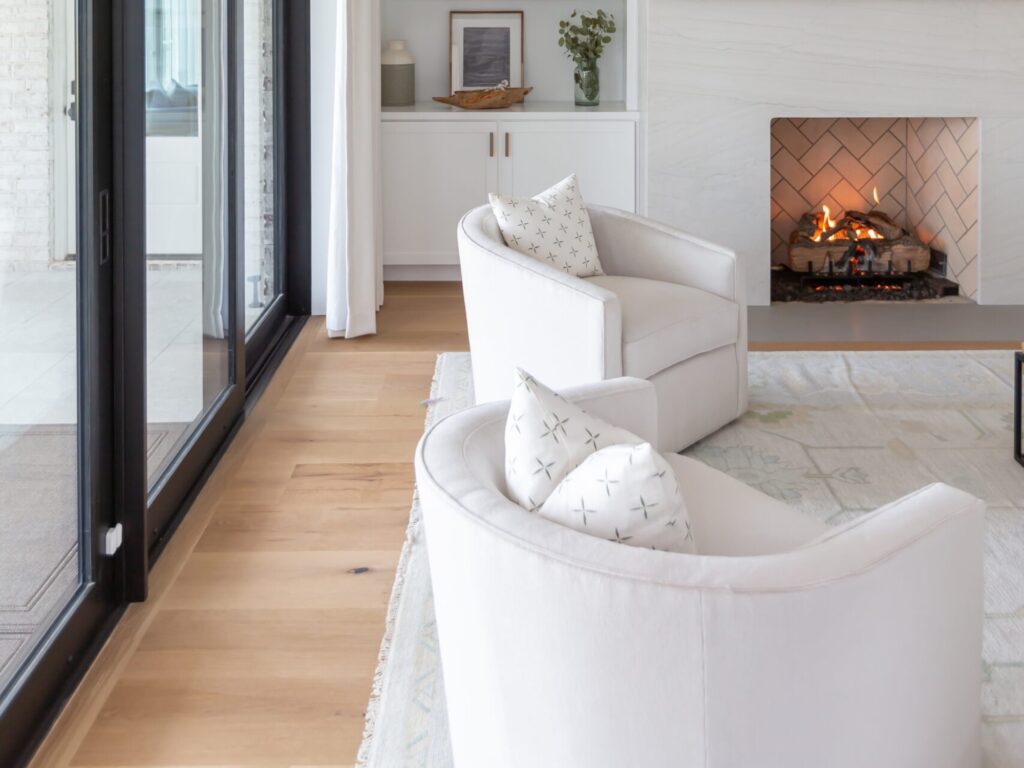 two sitting chairs and a fire in a den