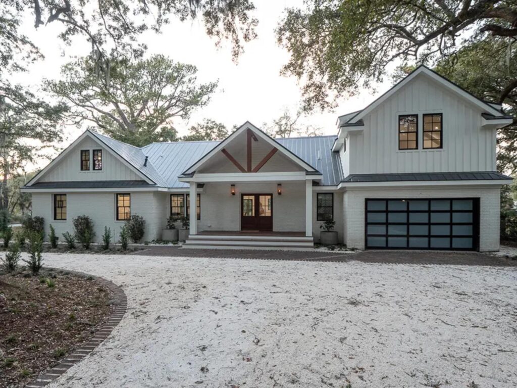 beautiful white home with gravel driveway