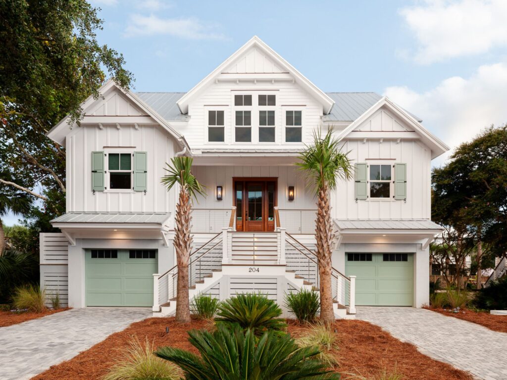 huge white home with light green garage doors and shutters - home renovation architect