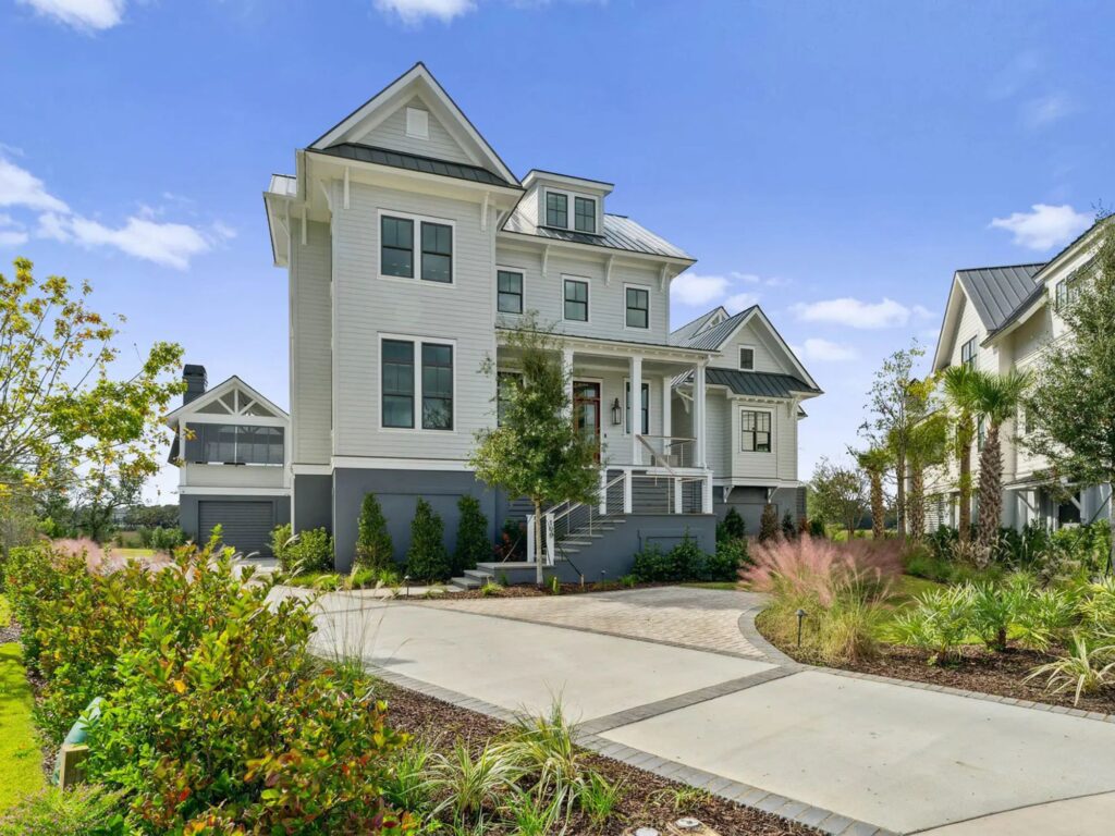 large home with large windows and beautiful landscaping