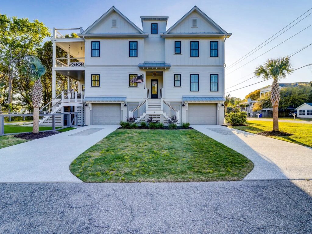 large home with wrap around porches and two driveways